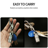 Keychain with multi-tool attachment held in hand and on keys against a dark background.