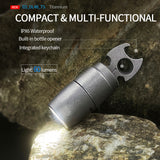 Compact multi-functional device with light, bottle opener, and keychain on a rock background
