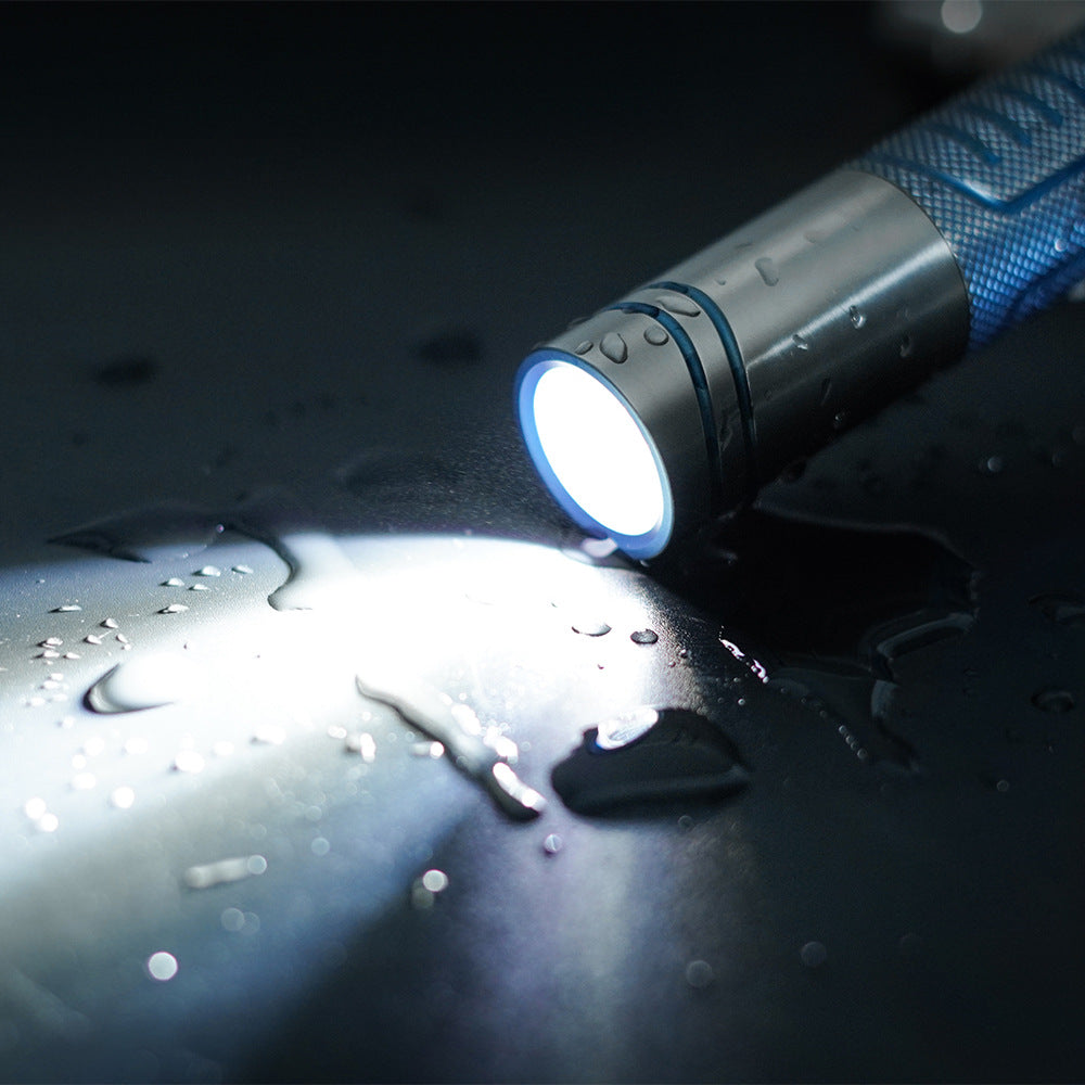 Titanium alloy ultra-bright flashlight with magnetic charging and secure magnetic attachment